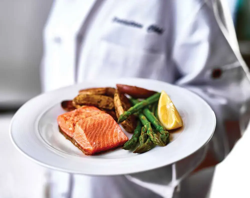 The Palms at La Quinta Chef Created Meals, chef delivering a finished dish.