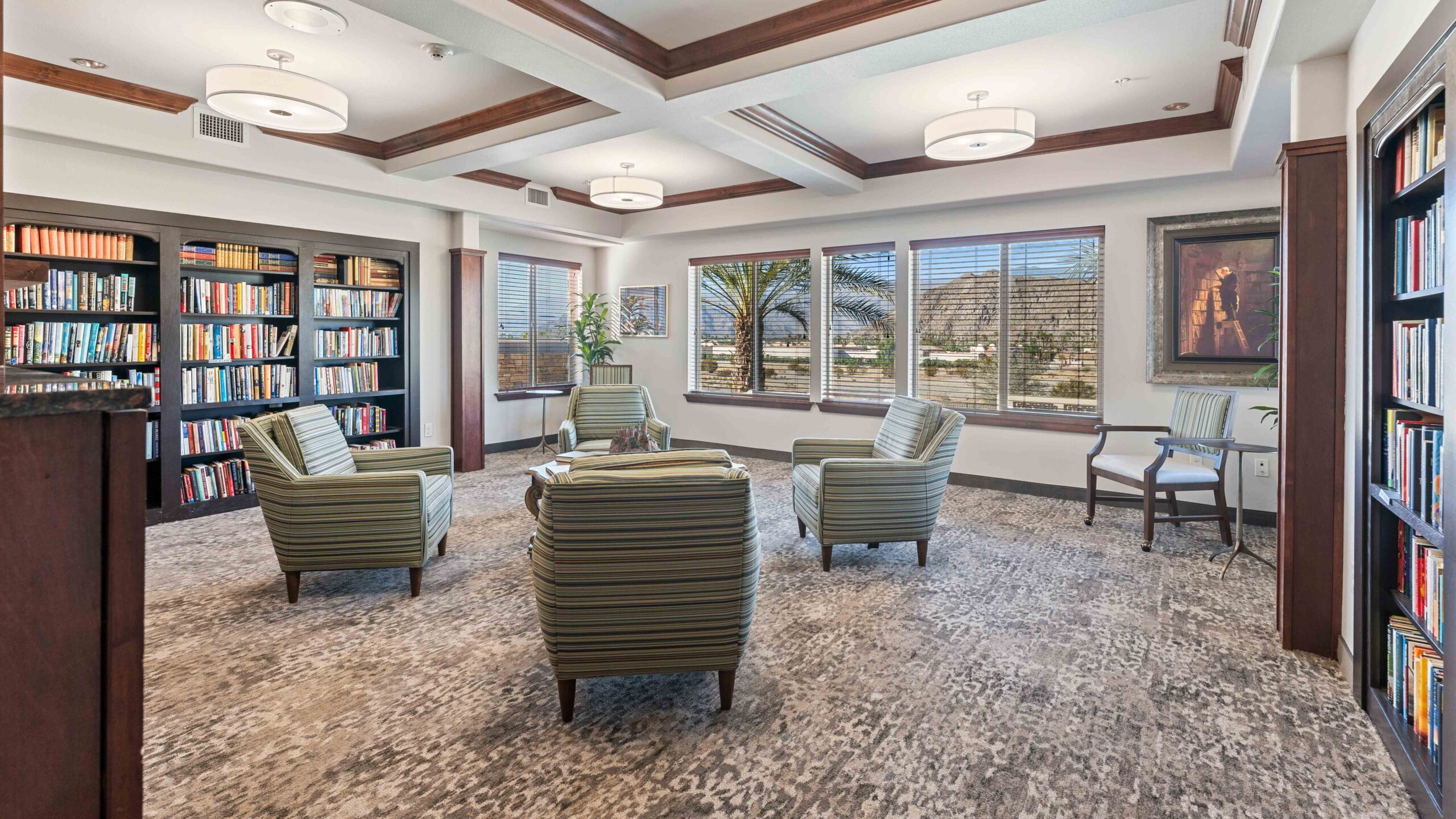 The library at The Palms at La Quinta with shelves of books and comfortable seating