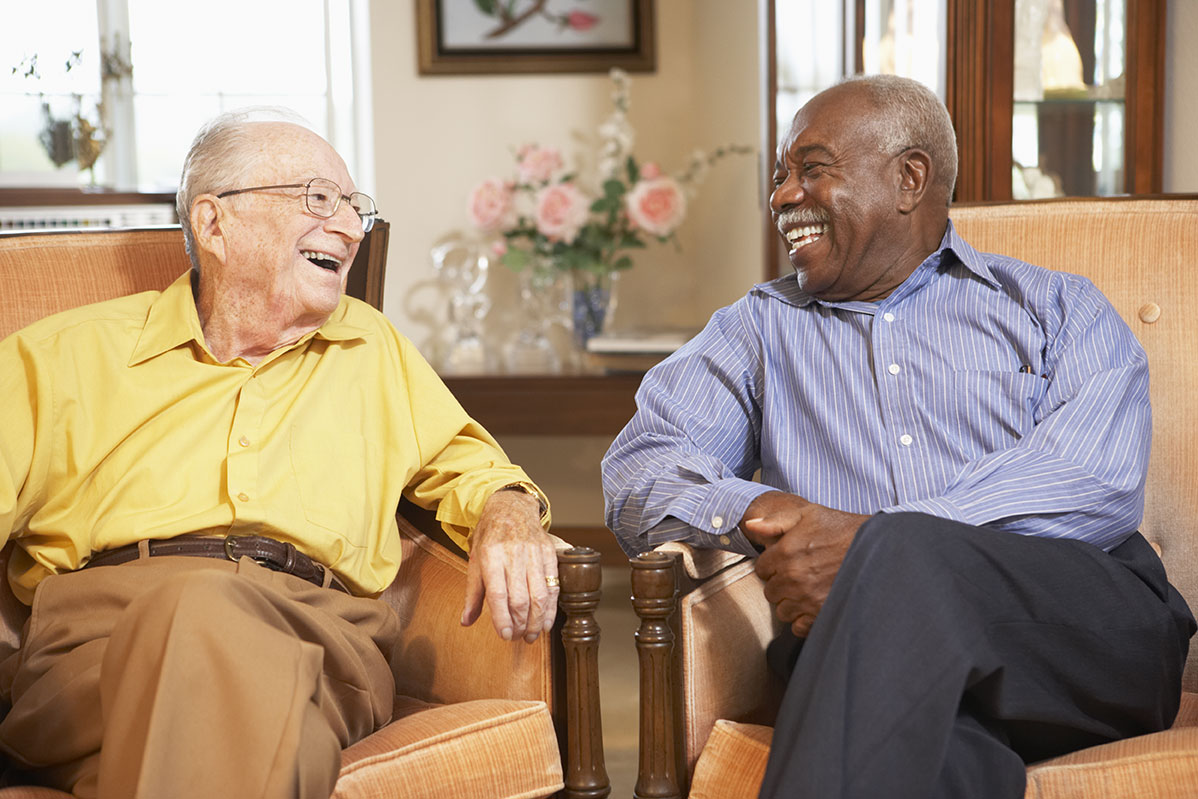 Residents laughing together at The Palms at La Quinta